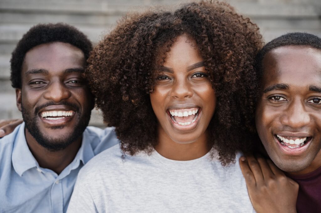 Young black people having fun looking at camera - Main focus on african woman face